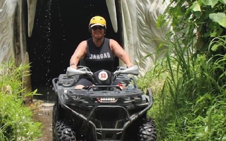 Quad riders on the muddy jungle loop at the Sedang ATV arena near Ubud