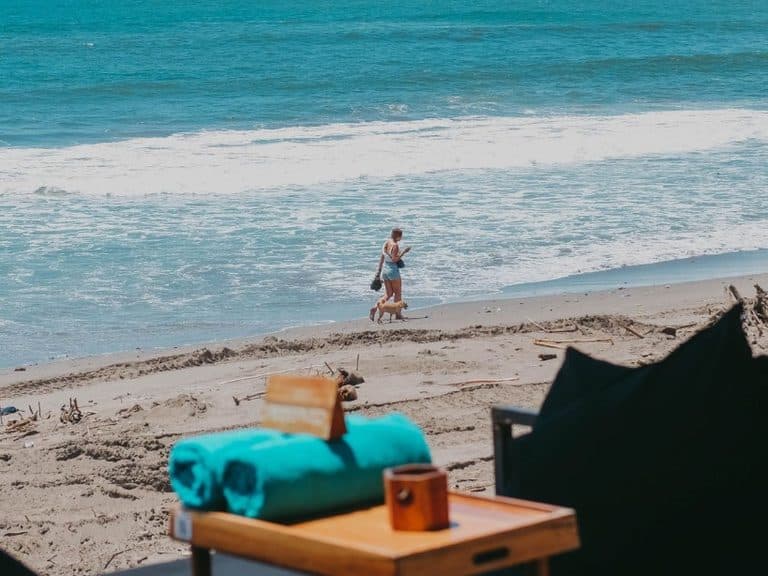 A beach-front table with rolled towels looking over the surf, the coast where early jeep pickups start