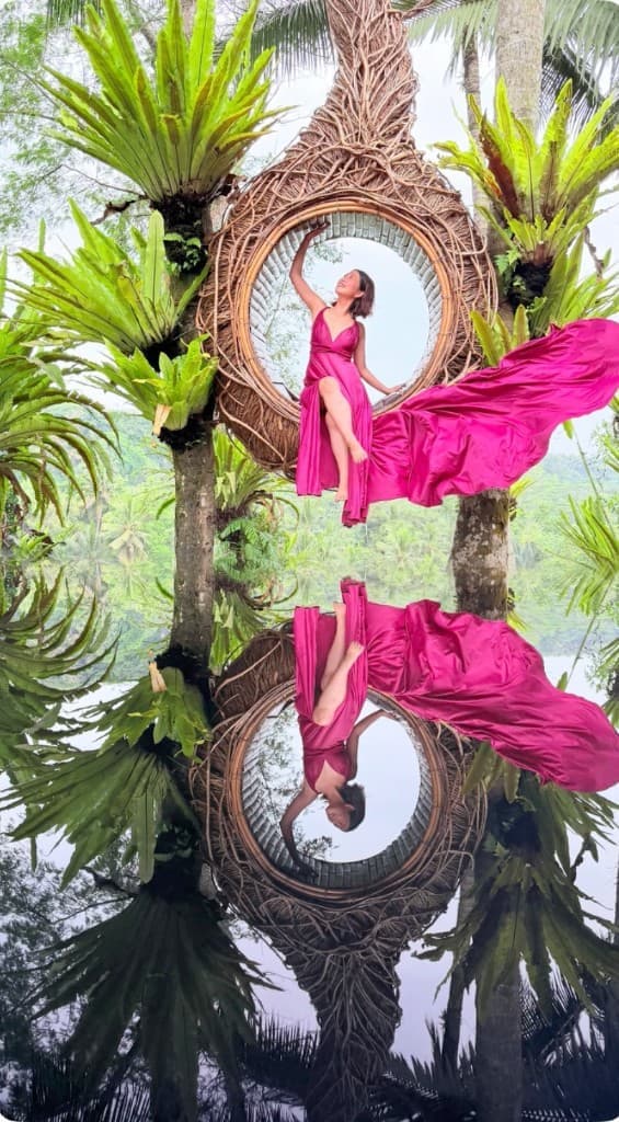 A guest in a magenta flying dress in the bird nest with a mirror reflection over the jungle